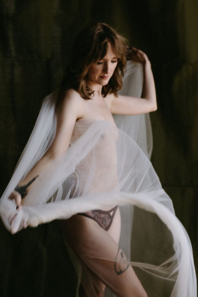 Whimsical image of a woman wrapped in tulle.